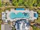 Aerial view of a community pool, lounge chairs, covered seating, clubhouse, parking, and landscaping at 8528 Quarter Horse Dr, Riverview, FL 33578
