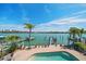 Enjoy stunning water views from the private pool and dock of this coastal home with tropical landscaping at 8685 E Bay Dr, Treasure Island, FL 33706
