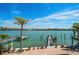 Enjoy stunning water views from the private pool and dock of this coastal home with tropical landscaping at 8685 E Bay Dr, Treasure Island, FL 33706