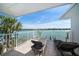 Balcony with water views, lounge chairs, and a view of the city skyline at 8685 E Bay Dr, Treasure Island, FL 33706