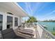 Relax on this spacious balcony with beautiful water views and lounge chairs to soak in the sun at 8685 E Bay Dr, Treasure Island, FL 33706