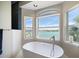 Enjoy stunning waterfront views from the comfort of this home's luxurious soaking tub at 8685 E Bay Dr, Treasure Island, FL 33706