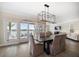 Elegant dining room features a modern chandelier and waterfront views from the sliding glass doors at 8685 E Bay Dr, Treasure Island, FL 33706