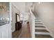 Inviting entryway boasting hardwood floors, staircase, and views into the home's open living space at 8685 E Bay Dr, Treasure Island, FL 33706