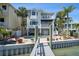 Back of a three story home overlooking the pool and waterway at 8685 E Bay Dr, Treasure Island, FL 33706
