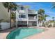 Rear exterior of home overlooking pool and waterfront at 8685 E Bay Dr, Treasure Island, FL 33706