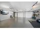 Spacious two car garage with painted floor, storage, and TV at 8685 E Bay Dr, Treasure Island, FL 33706