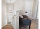A cozy landing area with a comfortable chair, lamp, and natural light coming from a window at 8685 E Bay Dr, Treasure Island, FL 33706