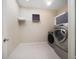 Convenient laundry room with modern washer and dryer units, plus extra storage space at 8685 E Bay Dr, Treasure Island, FL 33706