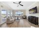 Bright living room with waterfront views, modern furniture, and a large flat-screen TV at 8685 E Bay Dr, Treasure Island, FL 33706
