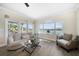Cozy living room with waterfront views from large windows and access to the outdoor balcony at 8685 E Bay Dr, Treasure Island, FL 33706