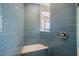 The luxurious shower features stylish blue tiling and an integrated bench at 8685 E Bay Dr, Treasure Island, FL 33706