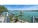 Backyard with waterfront views, a boat dock, and lush landscaping at 8685 E Bay Dr, Treasure Island, FL 33706