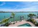 Waterfront backyard with a pool, dock, and beautiful water views at 8685 E Bay Dr, Treasure Island, FL 33706