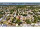 An aerial view showing a residential neighborhood with lush green trees and serene lake in the backdrop at 8829 93Rd St, Seminole, FL 33777
