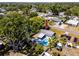 Aerial view of the house showcasing the backyard pool, spacious lot, and the home's location within a lush community at 8829 93Rd St, Seminole, FL 33777