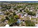Aerial view of a residential neighborhood with mature trees and glimpses of a bay in the distance at 8829 93Rd St, Seminole, FL 33777