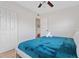 Cozy bedroom featuring a comfortable bed with blue accents, and a closet for ample storage at 8829 93Rd St, Seminole, FL 33777