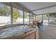 Inviting indoor pool area with a hot tub and outdoor views through the glass enclosure at 8829 93Rd St, Seminole, FL 33777