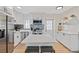 Bright and modern kitchen featuring white cabinetry, stainless steel appliances, and a stylish center island with seating at 8829 93Rd St, Seminole, FL 33777