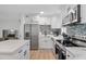 Updated kitchen boasts stainless steel appliances, modern white cabinets, and a beautiful backsplash for a contemporary feel at 8829 93Rd St, Seminole, FL 33777
