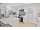 Bright kitchen features white cabinets, stainless steel appliances, mosaic backsplash, and light wood flooring at 8829 93Rd St, Seminole, FL 33777