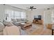 Cozy living room with neutral decor, wood floors, large window, and comfortable seating arrangement at 8829 93Rd St, Seminole, FL 33777
