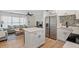 Open-concept living space connects a modern kitchen with a cozy living room, seamlessly blending style and functionality at 8829 93Rd St, Seminole, FL 33777