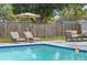 Outdoor pool with lounge chairs, umbrella and patio area for relaxation and fun at 8829 93Rd St, Seminole, FL 33777