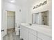 Bathroom featuring closet space and a vanity with a marble countertop and brushed nickel faucet at 9118 Lake Chase Island Way # 9118, Tampa, FL 33626