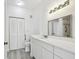 Bathroom featuring double closets and a vanity with a marble countertop and brushed nickel faucet at 9118 Lake Chase Island Way # 9118, Tampa, FL 33626