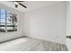 Bedroom with wood-look flooring, ceiling fan, and large window with a water view at 9118 Lake Chase Island Way # 9118, Tampa, FL 33626