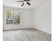 Bright room with hardwood floors, ceiling fan, and a window overlooking the neighborhood at 9118 Lake Chase Island Way # 9118, Tampa, FL 33626