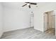 Light filled room with hard wood floors, ceiling fan, and two doors at 9118 Lake Chase Island Way # 9118, Tampa, FL 33626