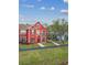 Close-up of a red townhome with charming architectural details at 9118 Lake Chase Island Way # 9118, Tampa, FL 33626