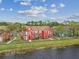 Scenic view of colorful townhouses with lush lawns and mature trees near a tranquil pond at 9118 Lake Chase Island Way # 9118, Tampa, FL 33626