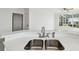 Kitchen island featuring stone countertop and sink with view to the outside at 9118 Lake Chase Island Way # 9118, Tampa, FL 33626