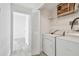 Laundry room featuring washer and dryer and storage shelves at 9118 Lake Chase Island Way # 9118, Tampa, FL 33626