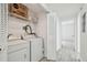 Bright laundry room featuring washer and dryer and storage shelves at 9118 Lake Chase Island Way # 9118, Tampa, FL 33626