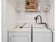 Laundry room featuring a washer and dryer and storage shelves at 9118 Lake Chase Island Way # 9118, Tampa, FL 33626