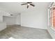 Bright and spacious living room featuring wood-look tile flooring and a window view at 9118 Lake Chase Island Way # 9118, Tampa, FL 33626