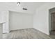Empty room featuring wood-look tile flooring and white trim at 9118 Lake Chase Island Way # 9118, Tampa, FL 33626