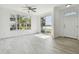 Spacious room with hardwood floors, ceiling fan, and decorative window above the entry door at 9118 Lake Chase Island Way # 9118, Tampa, FL 33626