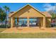 Open-air pool cabana features picnic tables and lake view, perfect for outdoor gatherings at 9118 Lake Chase Island Way # 9118, Tampa, FL 33626
