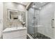 Modern bathroom featuring a glass-enclosed shower with a stone floor and a stylish vanity with a unique mirror at 100 4Th S Ave # 220, St Petersburg, FL 33701