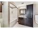 Bathroom featuring a tub-shower, vanity, and storage cabinet in a neutral color palette at 100 4Th S Ave # 220, St Petersburg, FL 33701
