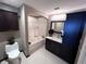 Bathroom featuring a tub-shower, vanity, and toilet in a neutral color palette at 100 4Th S Ave # 220, St Petersburg, FL 33701