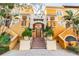 An exterior view of a yellow condo building with stairs on both sides of the front door at 100 4Th S Ave # 220, St Petersburg, FL 33701