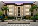 Building exterior with fountain, mature landscaping, and palm trees providing a welcoming entrance at 100 4Th S Ave # 220, St Petersburg, FL 33701