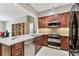Modern kitchen with stainless steel appliances, granite countertops, and wood cabinets offers great prep and cooking space at 100 4Th S Ave # 220, St Petersburg, FL 33701